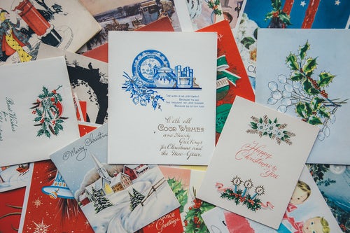 A dozen or so Christmas cards layed out.