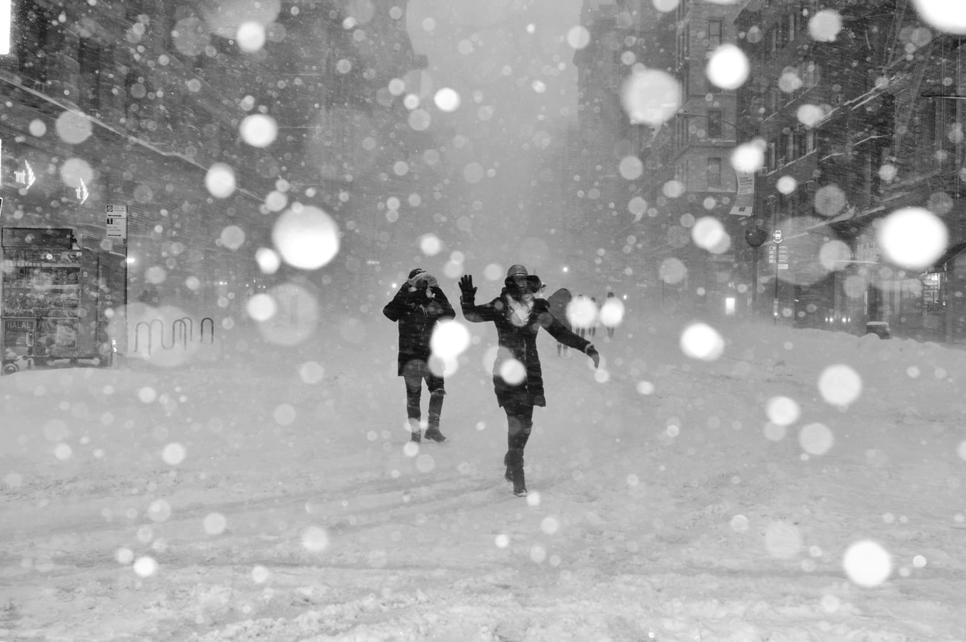 two people on a city street in a snow storm