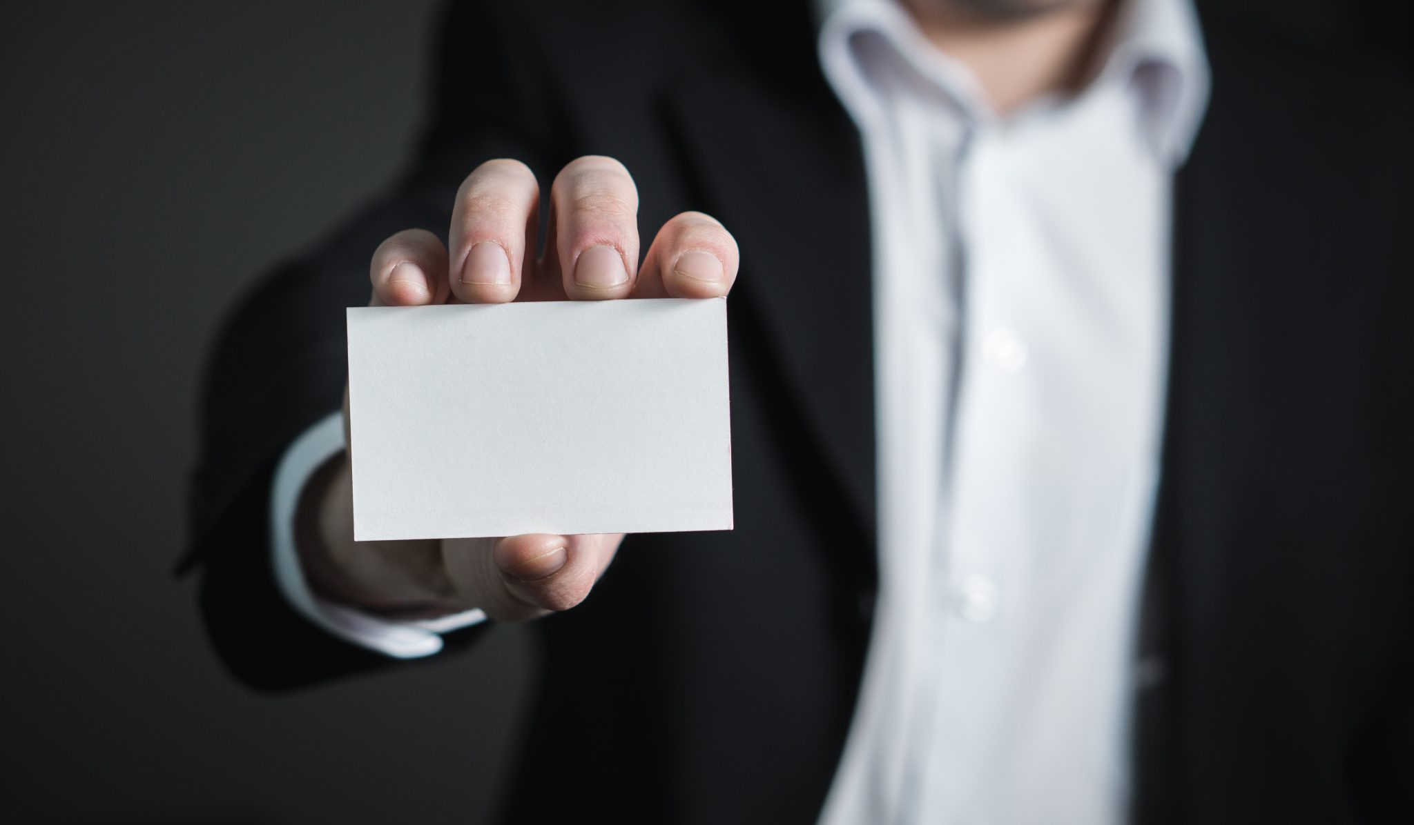 Mnan holding a blank business card