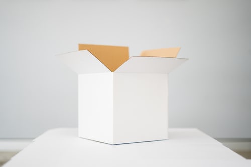 empty white box on a white table in a white room